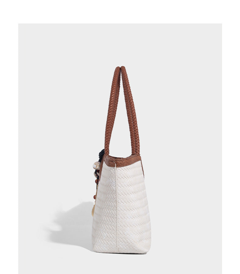 Large open-top woven tote bag with contrasting braided double handles and matching drawstring pouch, detail view 17