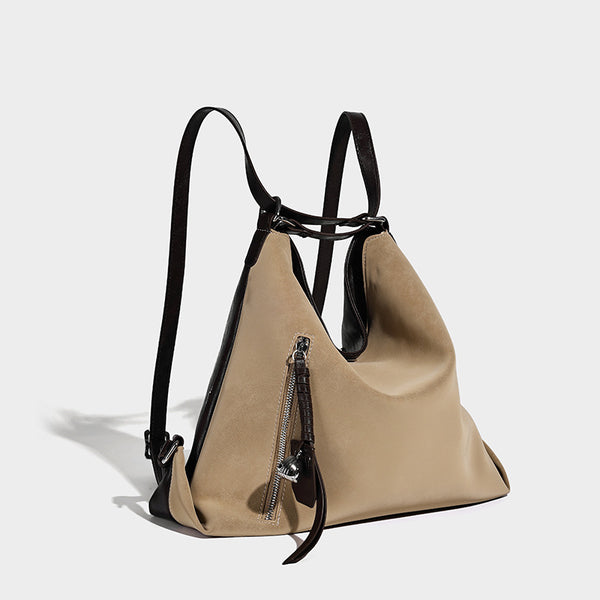 Slouchy hobo tote bag with matte leather-look finish, triangular silhouette, front zip pocket, and adjustable shoulder strap