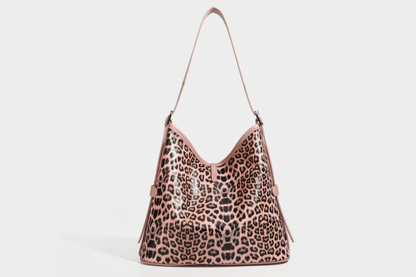 Slouchy leopard print shoulder hobo bag with black leather-look trim, tie-top closure, and single long strap, detail view 24