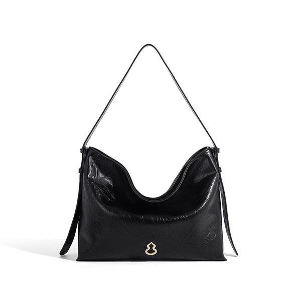 Large slouchy hobo shoulder bag in glossy crinkle leather-look finish with gold-tone emblem hardware and adjustable strap