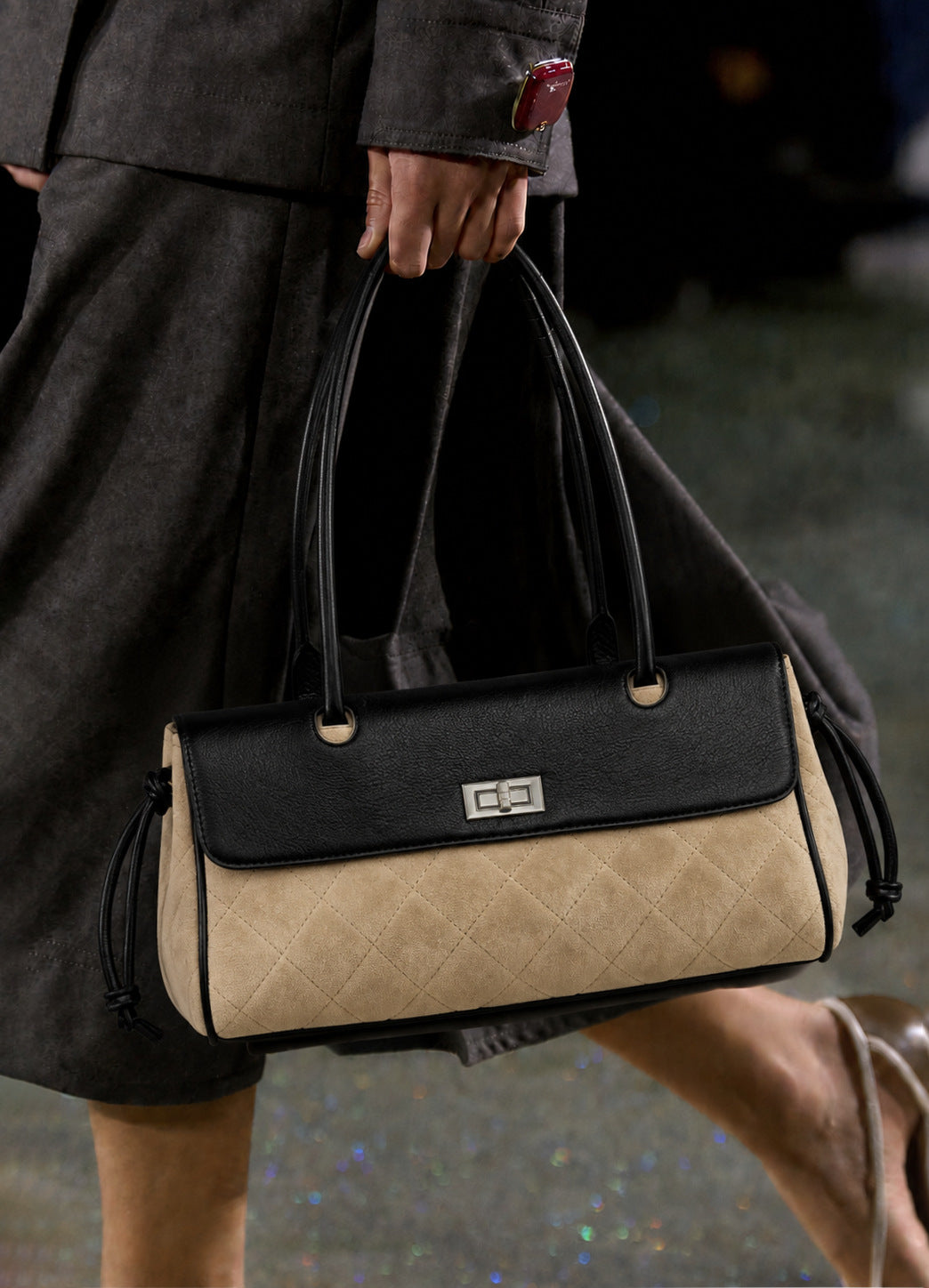 Compact two-tone quilted shoulder bag with black leather-look flap, silver turn-lock clasp, diamond-quilted body, side