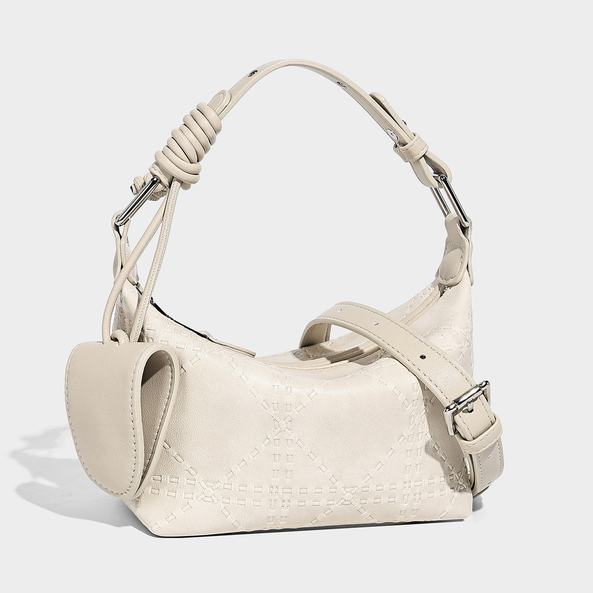 Small embossed half-moon shoulder bag with top zipper, detachable front pouch, and adjustable slim strap, front view