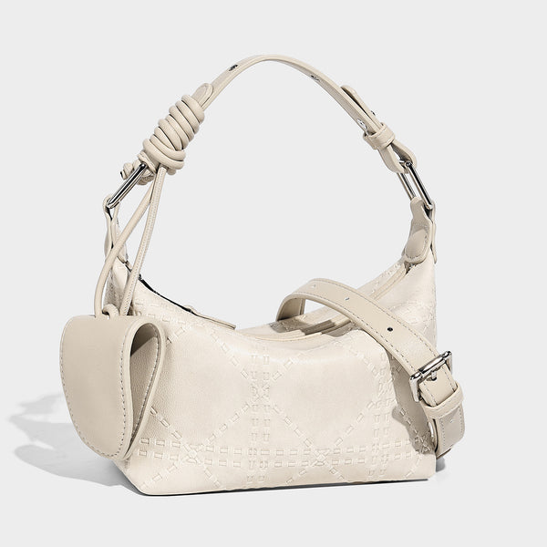 Small embossed half-moon shoulder bag with top zipper, detachable front pouch, and adjustable slim strap, front view