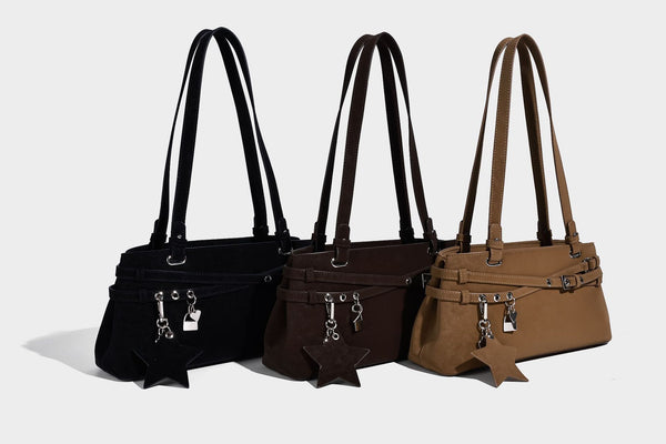 Structured trapezoid shoulder tote in dark brown matte suede-look finish with dual straps, wraparound belt bands