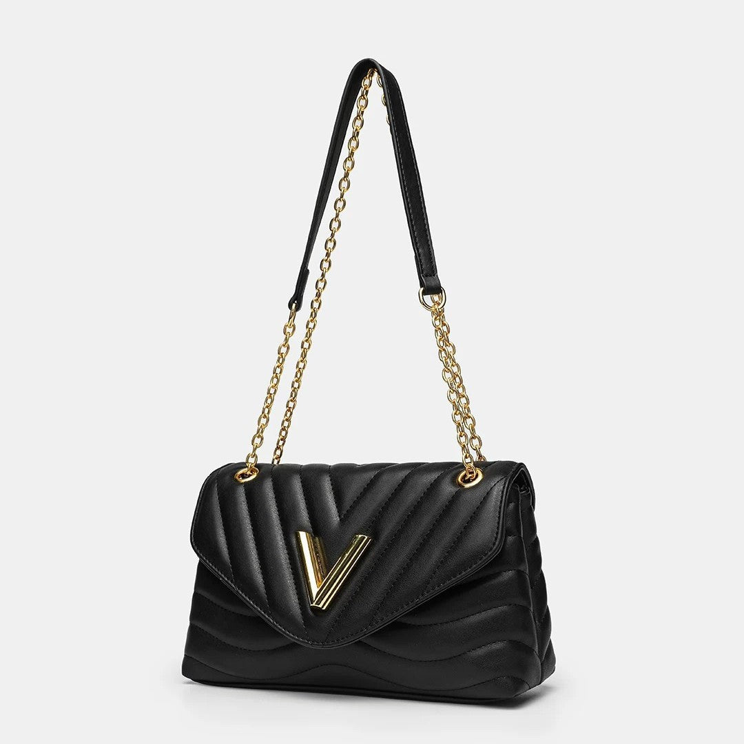 Small structured diamond-quilted flap shoulder bag with gold-tone V-shaped hardware and chain strap, detail view 2