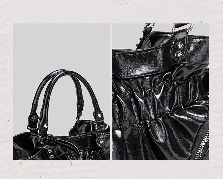 Black glossy ruched convertible tote bag with silver-tone rivets, detachable wide shoulder strap, external zip pouch, and