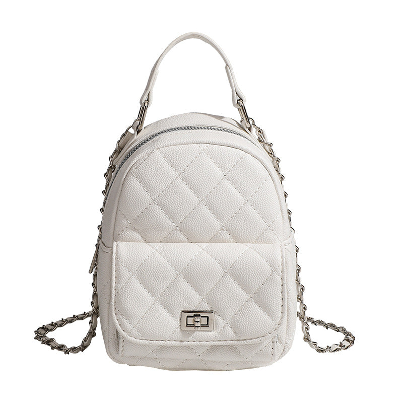 Compact diamond-quilted mini backpack handbag with silver-tone chain straps and turn-lock front pocket, detail view 5