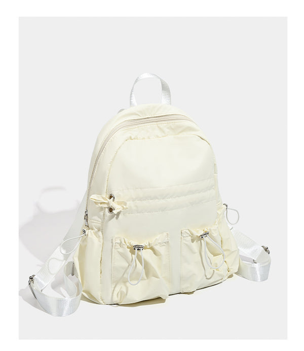 Puffy matte nylon mini backpack with drawcord gathered front pockets and silver-tone hardware, detail view 8