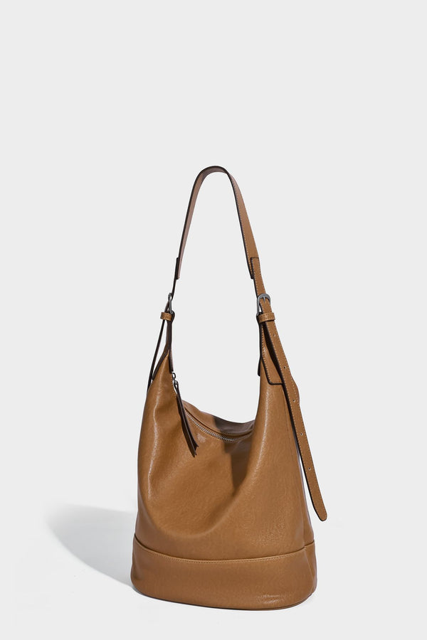 Slouchy bucket hobo shoulder bag in dark brown with glossy leather-look finish, top zip closure, and long adjustable, detail