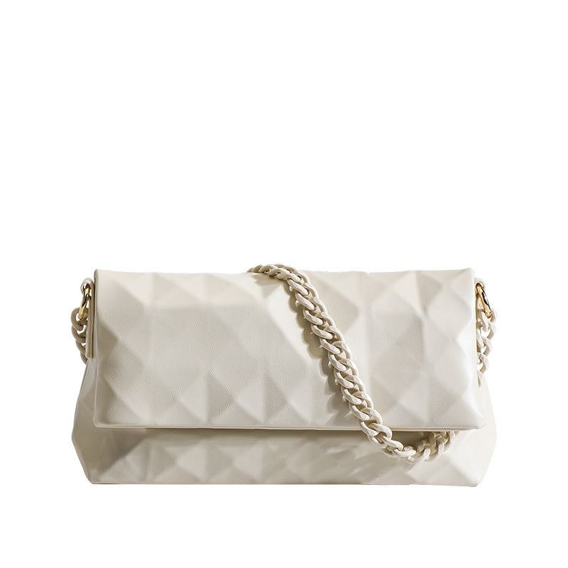 Cream white rectangular flap shoulder bag with geometric faceted surface and chunky tone-on-tone chain strap with gold-tone