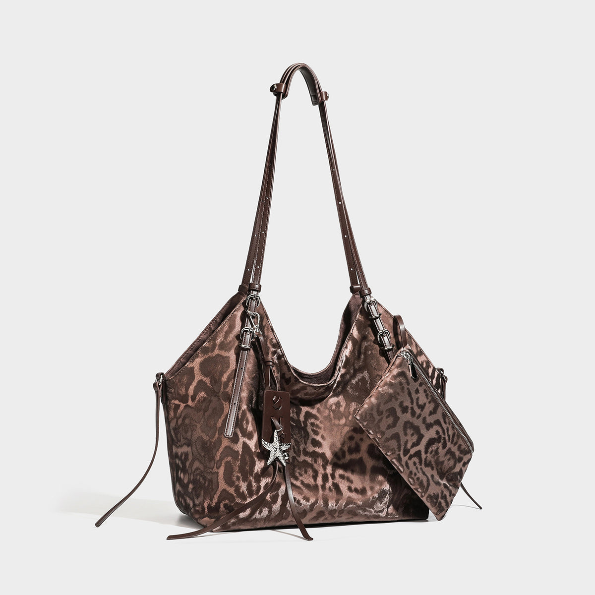Large glossy leopard-print hobo shoulder bag with detachable zip pouch and silver-tone starfish charm hardware, front view