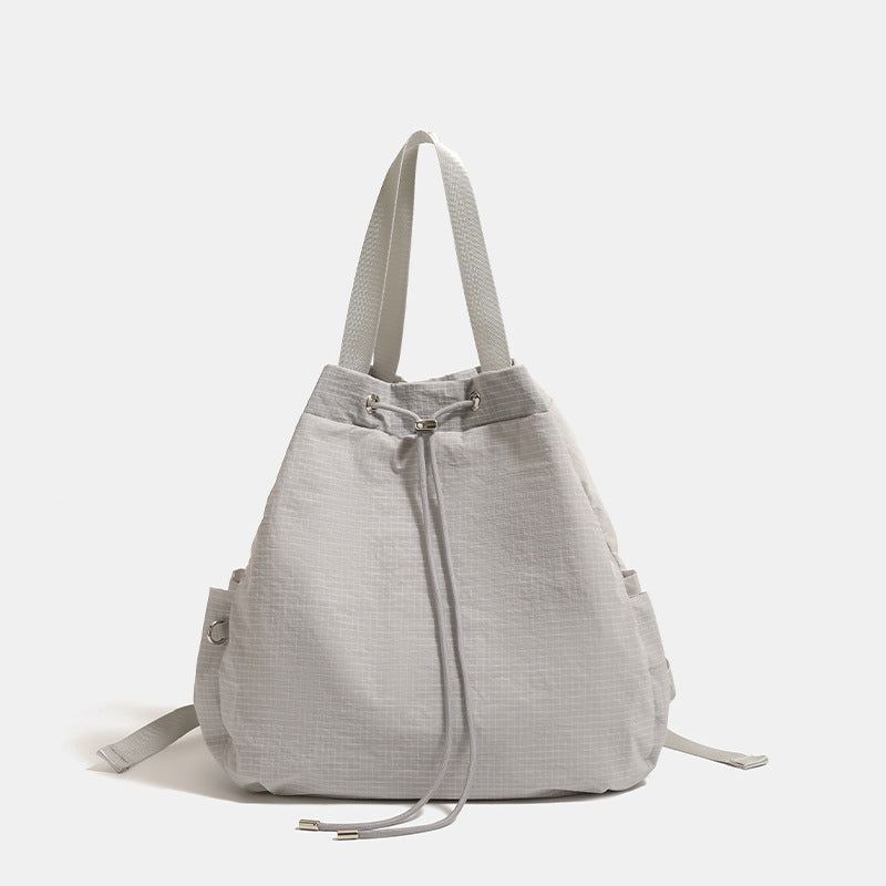 Glacier gray grid-texture nylon drawstring bucket convertible backpack with top handles and adjustable shoulder straps