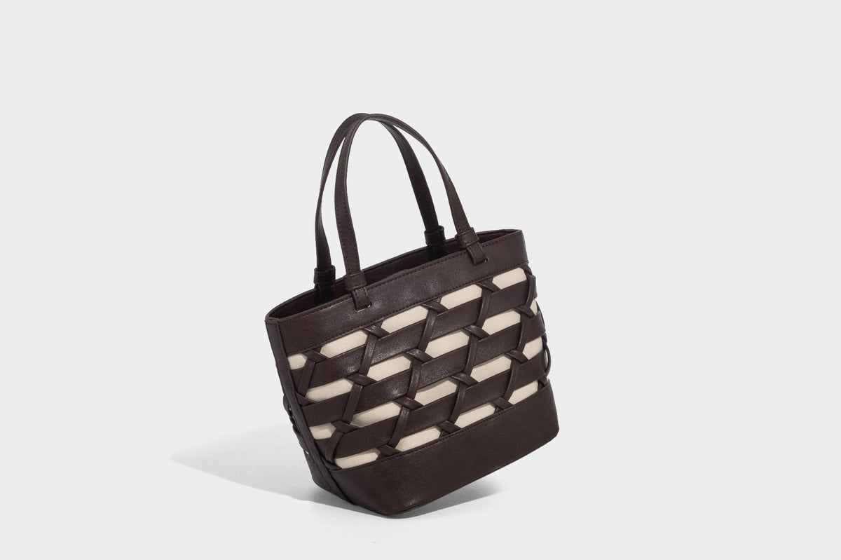 Structured woven lattice tote bag with cream lining, dual top handles, detachable crossbody strap, and silver-tone hardware