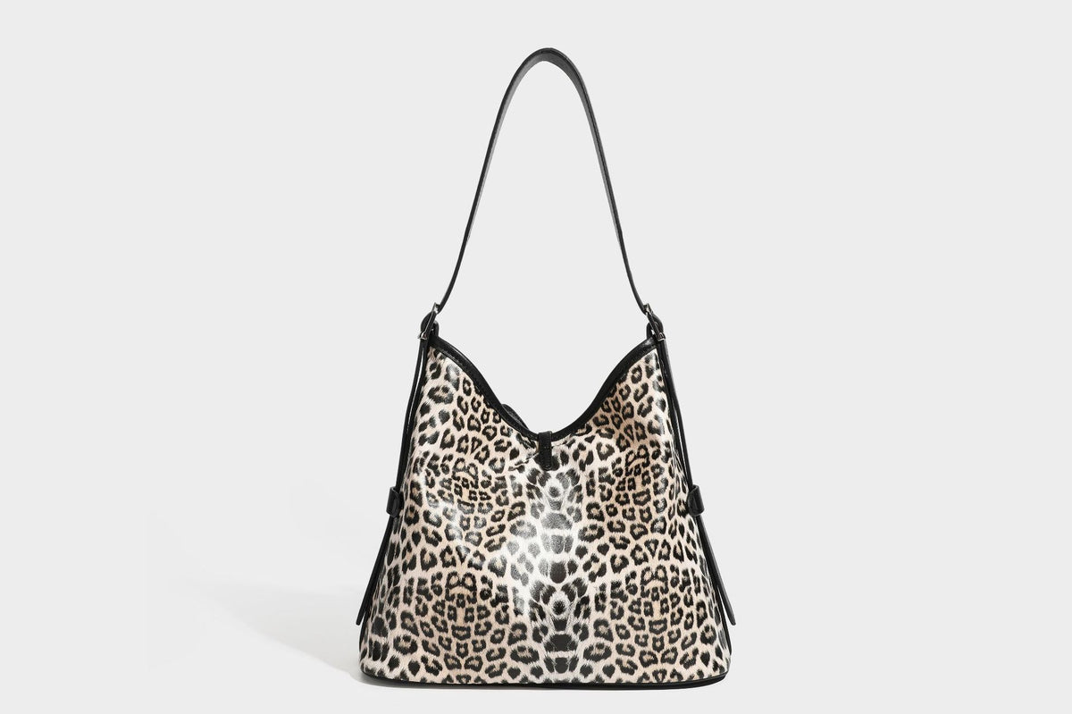 Slouchy leopard print shoulder hobo bag with black leather-look trim, tie-top closure, and single long strap, detail view 31