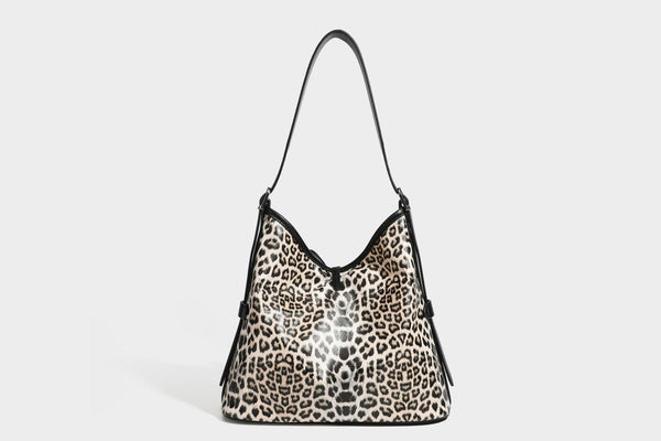Slouchy leopard print shoulder hobo bag with black leather-look trim, tie-top closure, and single long strap, detail view 31