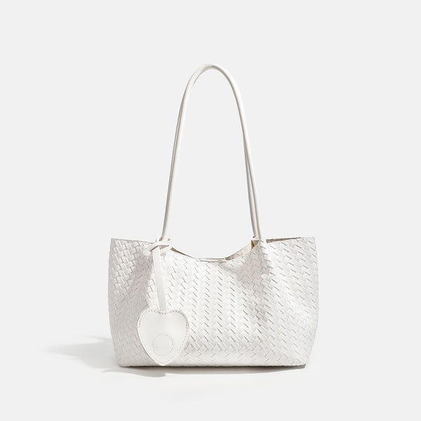 Woven leather-look tote bag in yellow with long shoulder straps, heart-shaped hanging charm, and removable inner zip pouch