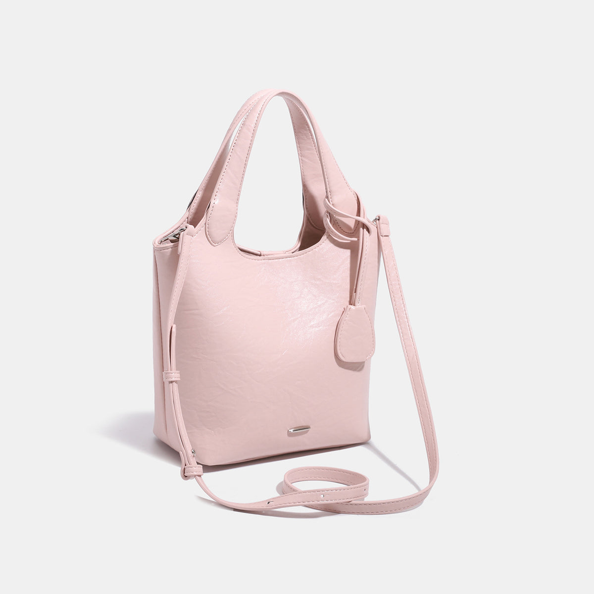 Soft glossy leather-look bucket tote bag with twin handles and detachable crossbody strap, detail view 3