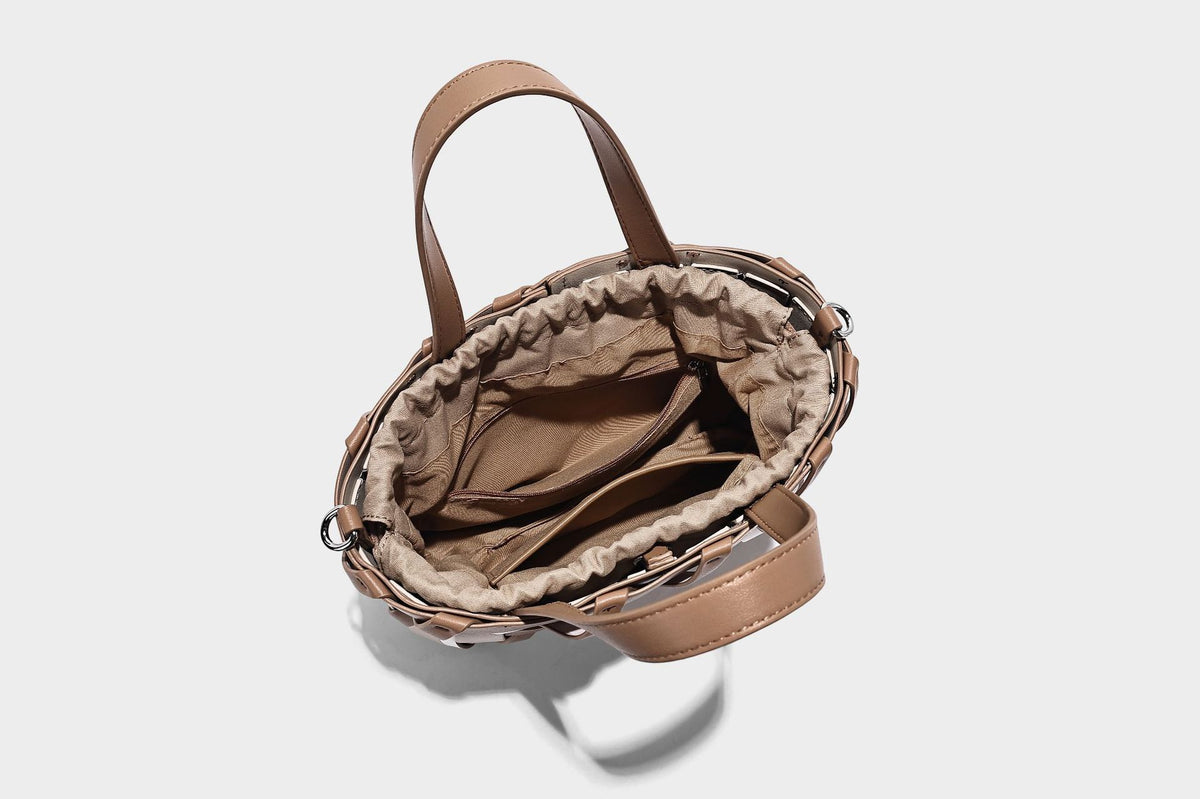 Small structured woven lattice tote bag with dual top handles and detachable shoulder strap in brown and cream leather-look