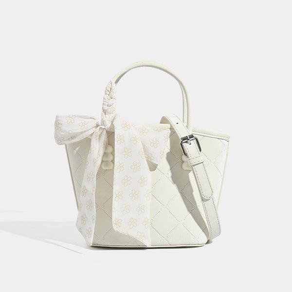 Quilted leather-look mini tote bag with printed scarf bow on braided top handle and silver-tone hardware, detail view 8