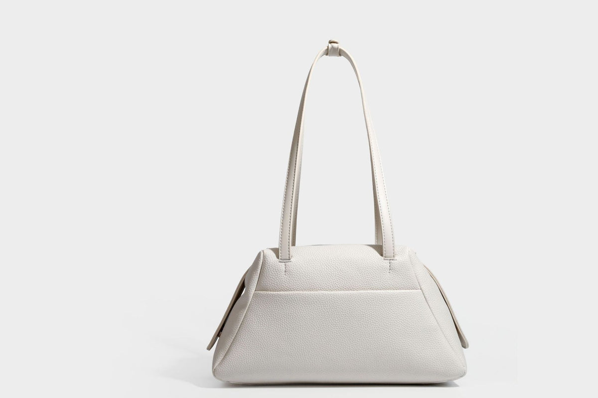 Structured trapezoid shoulder bag in dark brown pebbled leather-look finish with slim double straps, top zip closure, side