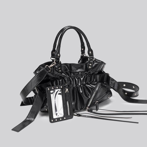 Black glossy ruched convertible tote bag with silver-tone rivets, detachable wide shoulder strap, external zip pouch, and