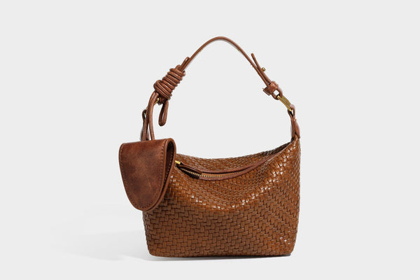 Small glossy basket-weave hobo shoulder bag in brown with knotted top handle, flap accent pocket, and gold-tone hardware