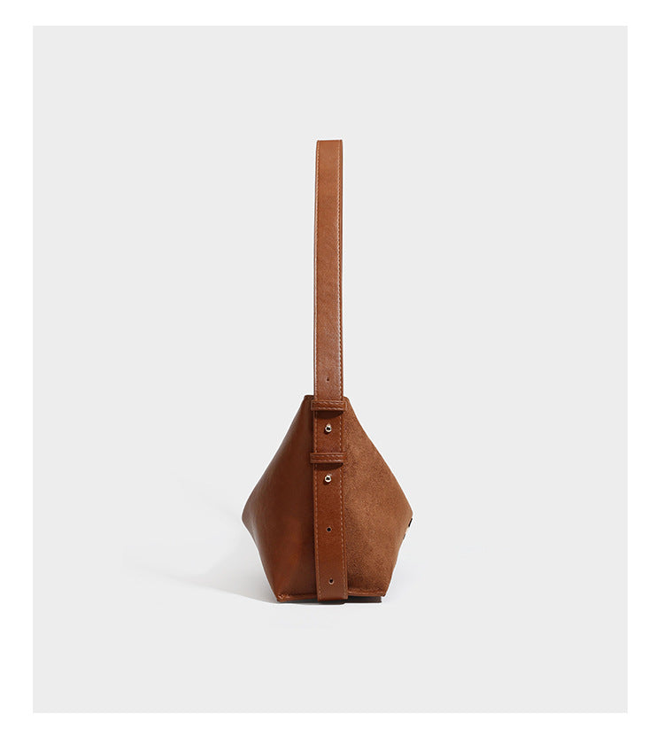 Slouchy suede-finish brown shoulder bag with long single strap and small gold-tone logo emblem on front, detail view 11