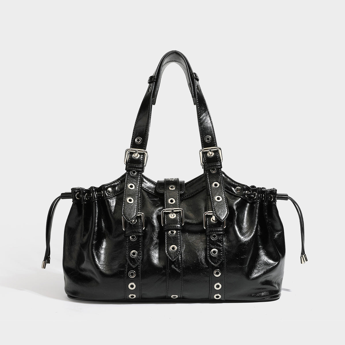Large black glossy leather-look tote bag with silver buckle straps, eyelet grommet panels, drawstring side gathers, and