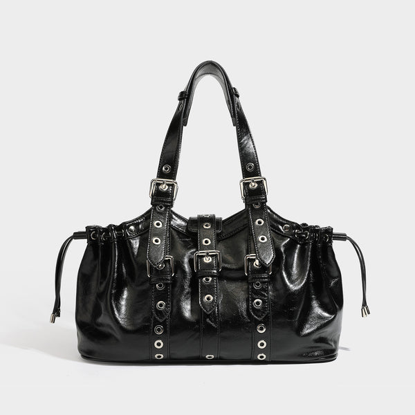 Large black glossy leather-look tote bag with silver buckle straps, eyelet grommet panels, drawstring side gathers, and