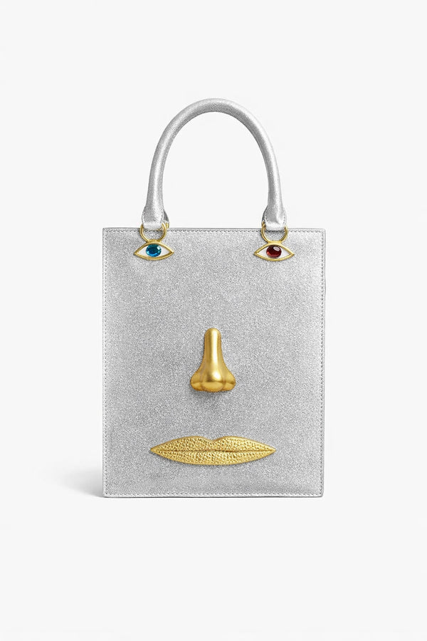 Structured rectangular top-handle bag in tan leather-look finish with gold-tone sculptural face hardware including
