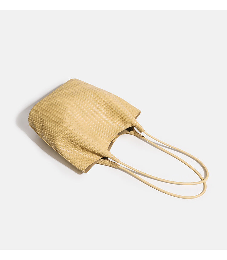 Large woven textured tote bag with long shoulder straps and structured rectangular base, detail view 9