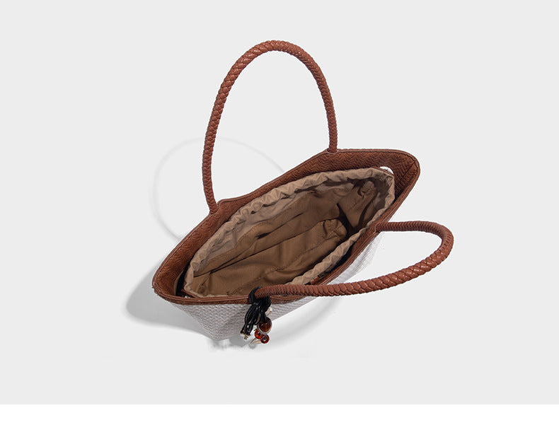 Large open-top woven tote bag with contrasting braided double handles and matching drawstring pouch, detail view 13