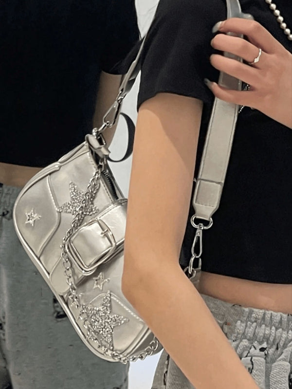 Compact metallic silver shoulder bag with glitter star appliqués, rhinestone star charms, front belt buckle strap, chunky