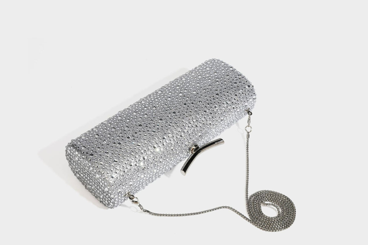 Structured rectangular hard-case clutch bag covered in all-over rhinestone crystal embellishment with curved kiss-lock top