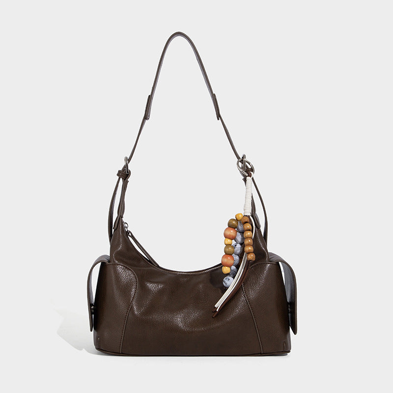 Soft pebbled leather-look hobo shoulder bag with zip top closure, side flap pockets, and silver-tone hardware, detail view 6