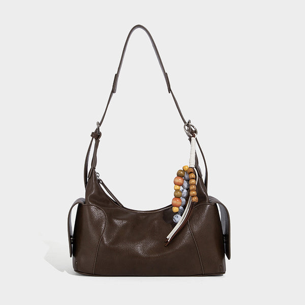 Soft pebbled leather-look hobo shoulder bag with zip top closure, side flap pockets, and silver-tone hardware, detail view 6