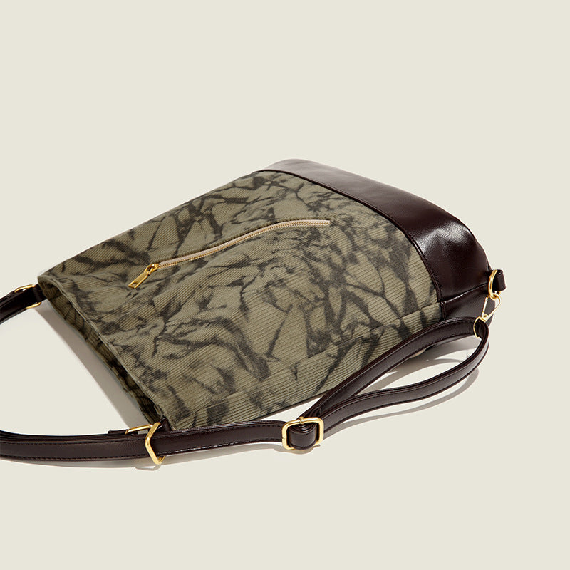 Large ink-wash printed corduroy hobo bag with dark brown leather-look base trim, diagonal front zip pocket, and gold-tone
