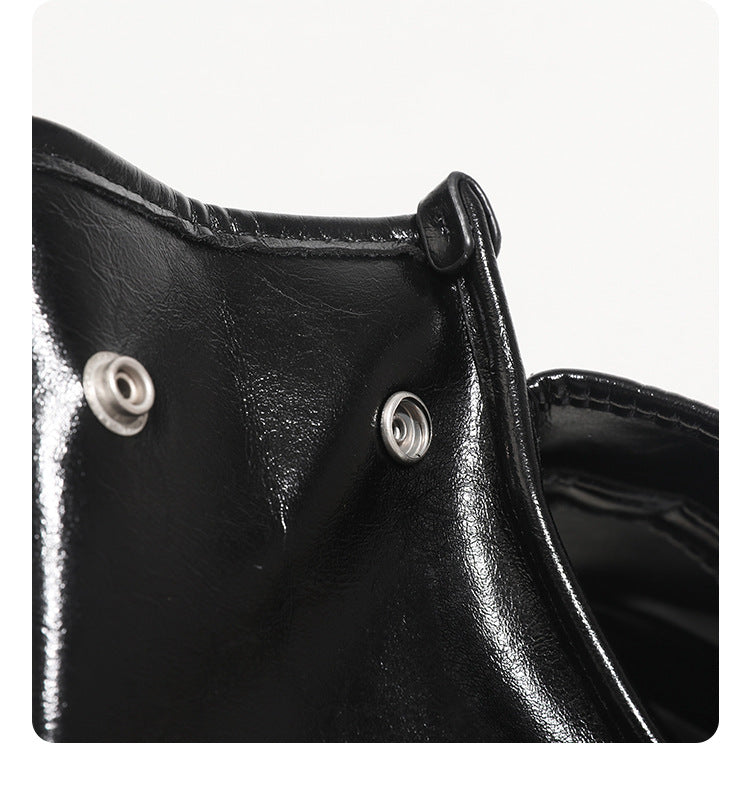 Structured glossy leather-look flap backpack handbag with dual buckle closures, top handle, and silver-tone hardware, detail