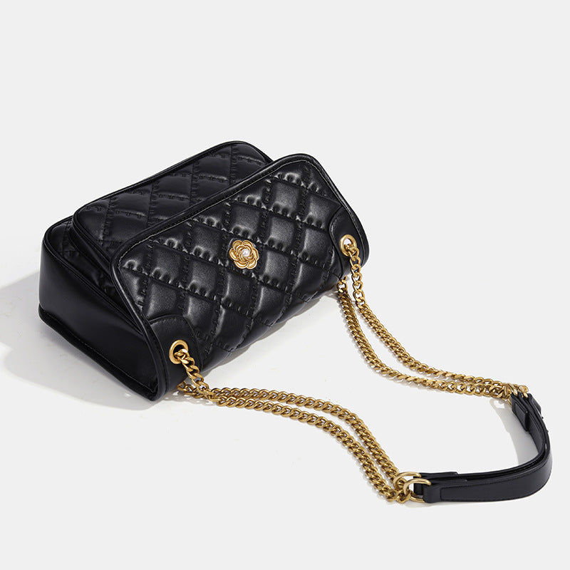 Compact diamond-quilted flap shoulder bag with gold-tone chain strap and floral turn-lock clasp, detail view 4