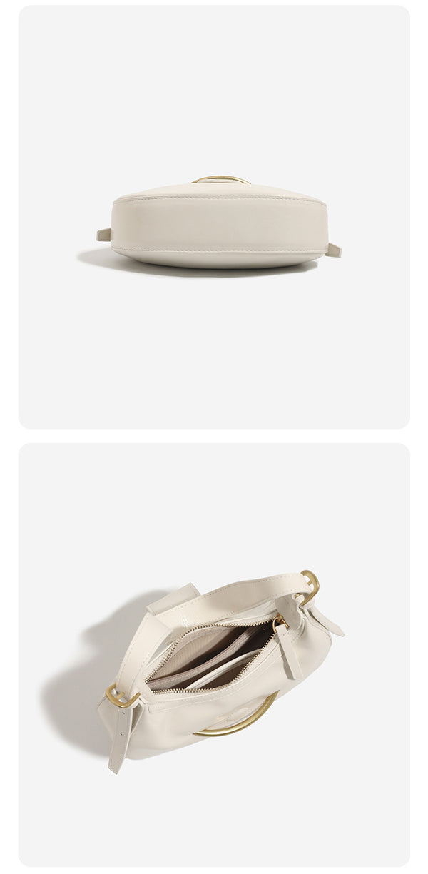 Compact crescent hobo shoulder bag with glossy synthetic finish, curved gold-tone front bar hardware, zip-top closure, and