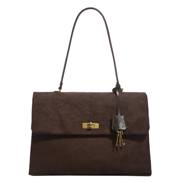 Large structured dark brown suede-finish satchel bag with gold-tone turn-lock closure, key charm accent, and detachable