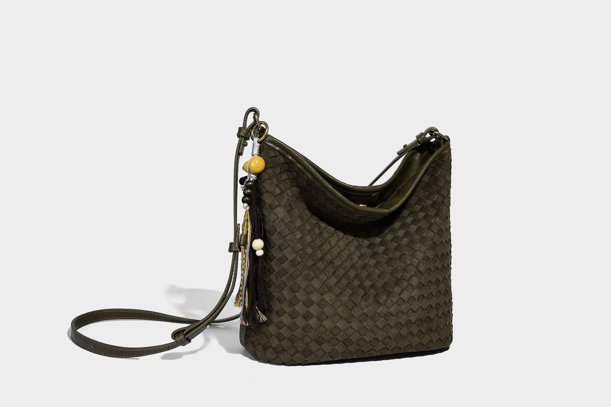 Dark chocolate woven texture hobo shoulder bag with multicolor tassel-and-bead charm and long adjustable strap, detail view