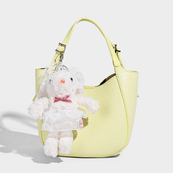 Small pebbled half-moon shoulder bag with dual top handles, detachable crossbody strap, and silver-tone hardware, detail view