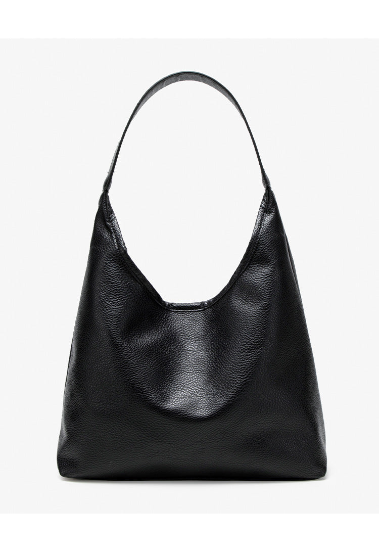 Large slouchy hobo shoulder bag in pebbled matte leather-look finish with single flat strap, detail view 11