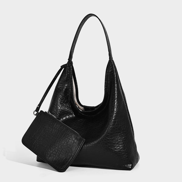 Slouchy hobo shoulder bag in pale yellow glossy pebbled leather-look finish with single shoulder strap and detachable front