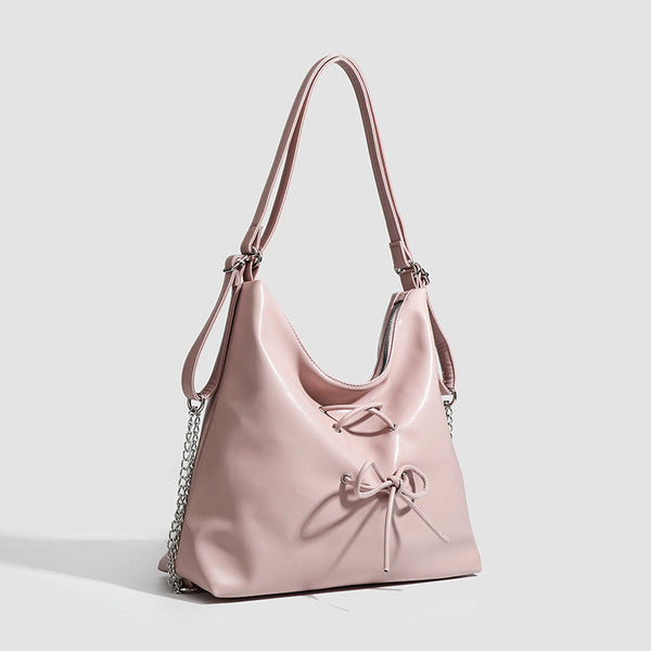 Glossy leather-look hobo shoulder bag with front bow lacing detail and silver-tone chain strap, detail view 3