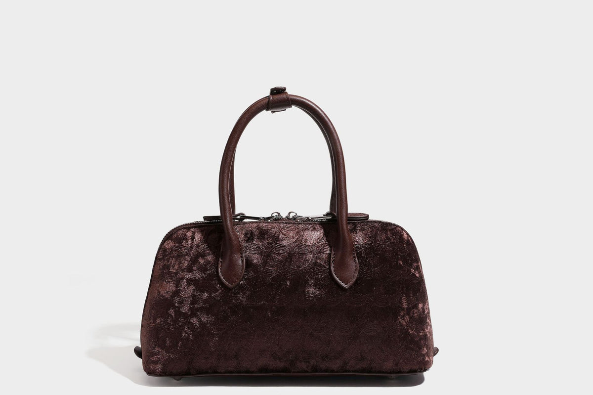 Small structured satchel bag in dark brown velvet-like textured finish with leather-look trim, silver-tone turn-lock bar