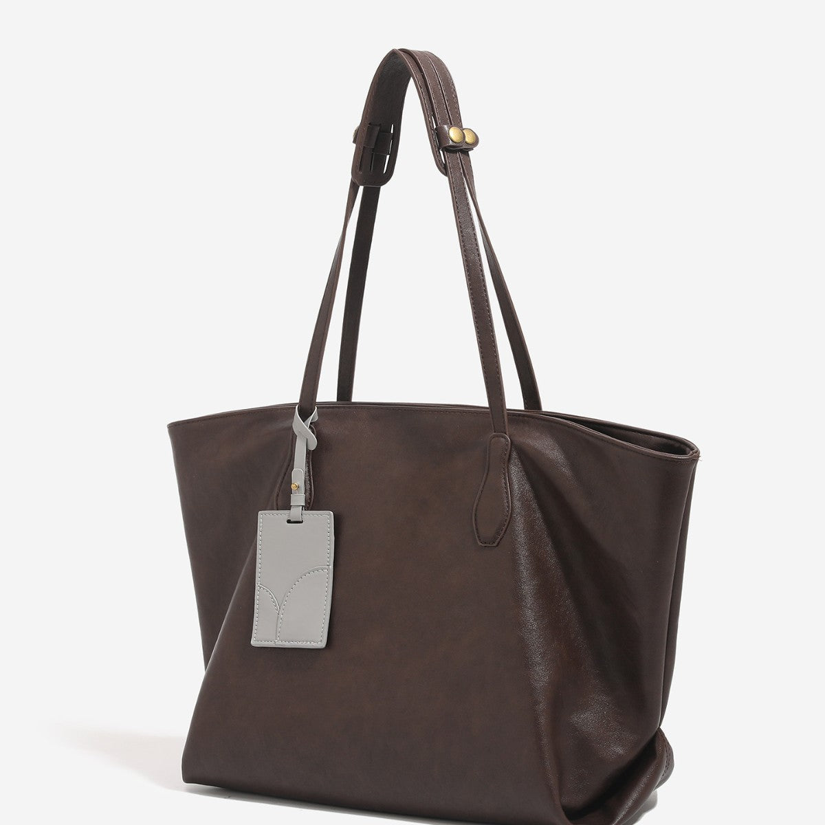 Oversized slouchy leather-look tote bag with long shoulder straps, contrast grey hanging tag, and silver-tone hardware