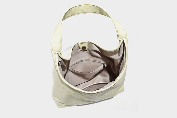 Slouchy hobo shoulder bag in pale yellow glossy pebbled leather-look finish with single shoulder strap and detachable front