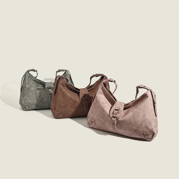 Slouchy distressed leather-look hobo bag with antique brass buckle closure and adjustable shoulder strap, detail view 2